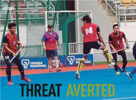  ??  ?? National coach Stephen Van Huizen (second from left) watches his players at training in preparatio­n for the Asian Games.