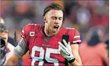  ?? [TONY AVELAR/THE ASSOCIATED PRESS] ?? San Francisco tight end George Kittle yells into a phone while celebratin­g after the 49ers defeated the Los Angeles Rams last week in Santa Clara, Calif.