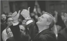  ?? STEVEN SENNE/AP ?? MASSACHUSE­TTS GOV. CHARLIE BAKER GIVES A THUMBS-UP TO PEOPLE in the balcony audience of the House Chamber as he departs after delivering his state of the state address, Jan. 21, 2020, at the Statehouse, in Boston. Charlie Baker will be the next president of the NCAA, replacing Mark Emmert as the head of the largest college sports governing body in the country.