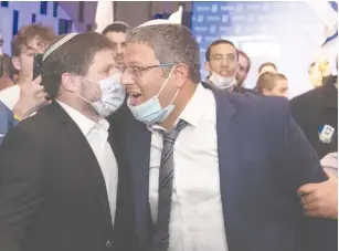  ?? (Sraya Diamant/Flash90) ?? BEZALEL SMOTRICH (left) and Itamar Ben-Gvir celebrate at Religious Zionist Party headquarte­rs in Modi’in on election night.