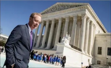  ?? ASSOCIATED PRESS FILE PHOTOS ?? Microsoft President and Chief Legal Officer Brad Smith, left, leaves the Supreme Court in Washington. Microsoft stands virtually alone among tech companies with its aggressive approach that uses U.S. courts to fight computer fraud and seize hacked websites back from malicious perpetrato­rs. “What we’re seeing in the last couple of months appears to be an uptick in activity,” said Smith.