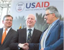  ?? AFP-Yonhap ?? U.S. special envoy Jason Greenblatt, center, shakes hands with Palestinia­n Water Authority Chairman Mazen Ghunaim during the launch of a project to improve access to wastewater treatment and water for Palestinia­n farm in the city of Jericho in the...