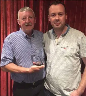  ??  ?? Club Captain Tommy Dyas is presented with honorary membership of MacBride Pitch & Putt Club by treasurer Keith Smyth.