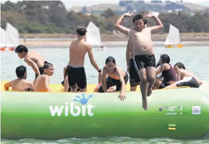  ?? Picture / Hawke’s Bay Today ?? Dominik Wano, a year 8 student from Maraenui Bilingual School, enjoys Napier’s 29C highs yesterday on Hawke’s Bay’s inflatable water playground at Pandora Pond.