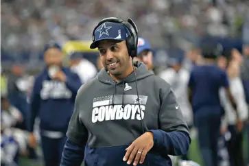  ?? AP Photo/Roger Steinman ?? ■ Dallas Cowboys defensive line coach Aden Durde walks on the sideline during the first half of an NFL game against the Atlanta Falcons on Nov. 14 in Arlington, Texas. Durde is the first British-born coach to get a full-time job in the NFL. He is a product of the league’s coaching diversity programs.