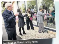  ??  ?? Celebratio­n Nette’s family raise a glass on her 100th birthday