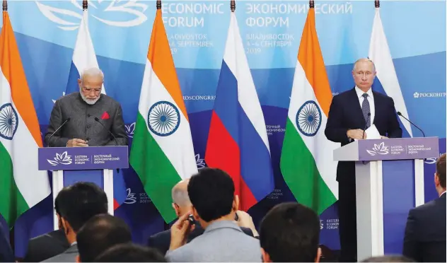  ?? Agence France-presse ?? ↑ Narendra Modi and Vladimir Putin attend a joint press conference in Vladivosto­k on Wednesday.