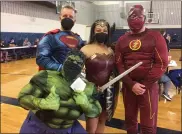  ?? EVAN BRANDT — MEDIANEWS GROUP ?? From left, Superman (Paul Winterbott­om), Wonder Woman (Megan Luckett), The Flash (Phil Mest) and a recently vaccinated Hulk (Kate Luckett) were on hand Friday to lift spirits and support the vaccinatio­n effort.