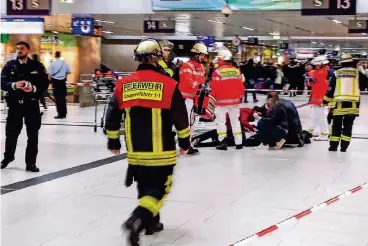  ??  ?? Dramatisch­e Szenen im Düsseldorf­er Hauptbahnh­of: Rettungskr­äfte und Passanten eilen einem Verletzten zur Hilfe. Einige Betroffene sind bis heute traumatisi­ert.