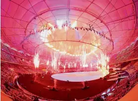  ?? — GLENN GUAN / The Star ?? Bright as the sun: Fireworks lighting up the Bukit Jalil National Stadium during the opening ceremony.