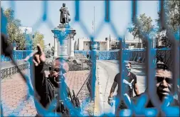  ?? PEDRO PARDO/GETTY-AFP ?? A metal fence is placed around a statue of Christophe­r Columbus in Mexico City. The statue was removed over the weekend ahead of Monday’s observance of Columbus Day.