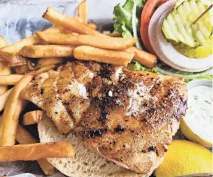  ?? WADE TATANGELO/SARASOTA HERALD-TRIBUNE ?? A blackened grouper sandwich at The Old Salty Dog on Sarasota’s City Island