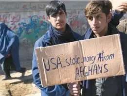  ?? HUSSEIN MALLA/AP ?? Afghans in Kabul protest President Joe Biden’s decision in February to split $7 billion in frozen Afghan assets to fund relief in Afghanista­n and compensate 9/11 victims.