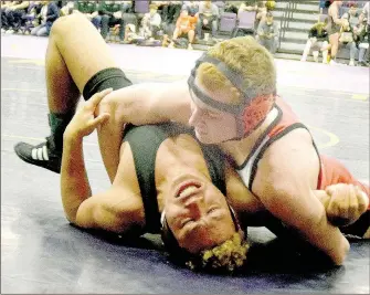  ?? PHOTO BY RICK PECK ?? McDonald County’s Truman Craig has Myron Reeves of Clinton (Oklahoma) on his back on the way to a pin to win the 160-pound division of Saturday’s Monett Wrestling Tournament.