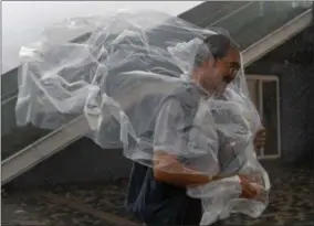  ?? THE ASSOCIATED PRESS ?? A man braves the wind on the waterfront of Victoria Habour as Typhoon Haima approaches Hong Kong, Friday, Oct. 21, 2016. Typhoon Haima churned toward southern China on Friday after smashing into the northern Philippine­s with ferocious wind and rain,...