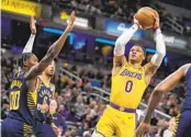  ?? MICHAEL CONROY AP ?? Russell Westbrook (0) takes a shot in one of his final games with Lakers before three-team trade to Utah.