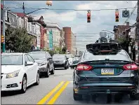  ?? AP/GENE J. PUSKAR ?? A self-driving Uber car stops at a red light on Liberty Avenue through the Bloomfield neighborho­od of Pittsburgh in September.