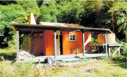  ?? Photo / Pete Shaw ?? One of the Department of Conservati­on back country huts in Te Urewera given historic status within the department, Waiotukapi­ti Hut.