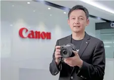  ?? ?? Zhang poses with the new Canon EOS R3 camera. The Canon EOS R3 is the latest camera under Canon’s advanced EOS R system.