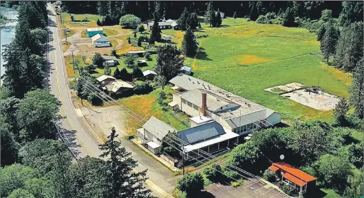  ?? LANDANDWIL­DLIFE.COM/AP ?? This undated aerial photo taken from a drone video and provided by Landandwil­dlife.com, shows Tiller, Ore. Almost all of the downtown in Tiller, a dying timber town in remote southweste­rn Oregon, is for sale for $3.5 million and the elementary school...