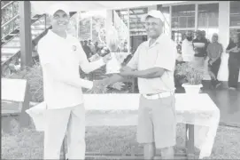  ??  ?? Avinash Persaud (right) accepts his trophy from Minister of Communitie­s, Ronald Bulkan.