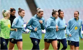  ?? Photograph: Dan Himbrechts/AAP ?? Matildas players warm up during Friday’s training session at Stadium Australia before their first friendly against the USA on Saturday.