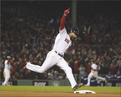  ?? The Associated Press ?? Boston Red Sox’s Eduardo Nunez reacts as he runs the bases after hitting a three-run home run against the Los Angeles Dodgers during the seventh inning of Game 1 of the World Series on Tuesday night in Boston. The Red Sox won 8-4.