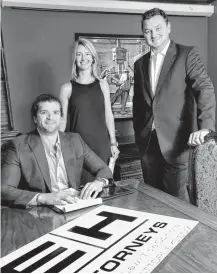  ??  ?? Nathan Enos and Ted Hans started Enos and Hans Attorneys PLLC specializi­ng in oil-field law in 2014, just in time for the oil industry to slow. Shown in the firm’s midtown office on Classen Drive are Enos, seated, and standing Laura Rudnicki and Hans.