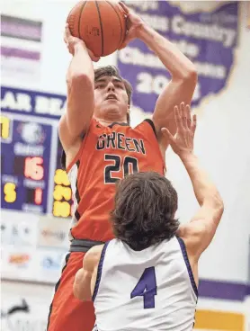  ?? ?? Green’s Brady Rollyson shoots over Jackson’s Cole Baker during a high school boys basketball game at Jackson on Jan. 12.