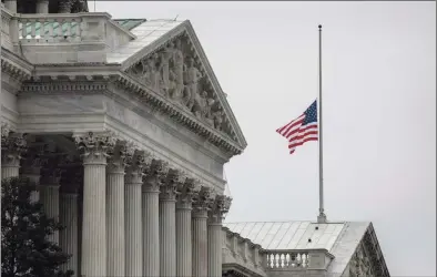  ?? John Moore / TNS ?? The U.S. flag flies at half-staff at the Capitol building on Friday,. House Speaker Nancy Pelosi ordered the building's flags be flown at half-staff in honor of Capitol Police Officer Brian Sicknick, 42, who died after being injured during clashes with a mob of supporters of President Donald Trump, at the Capitol on Wednesday.