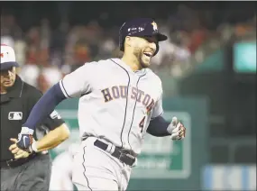  ?? Rob Carr / Getty Images ?? AL hitter George Springer of the Astros celebrates while rounding the bases after hitting a home run in the 10th inning of the All-Star Game on Tuesday.