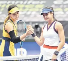  ?? — AFP photo ?? Raducanu (right) congratula­tes China’s Wang Xinyu after their singles match of the WTA Upper Ladies Austria in Linz, Austria.