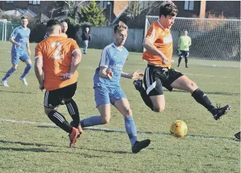  ??  ?? Action from the Cambs Cup semi-final between Thorney (orange) and Whittlesey Athletic.