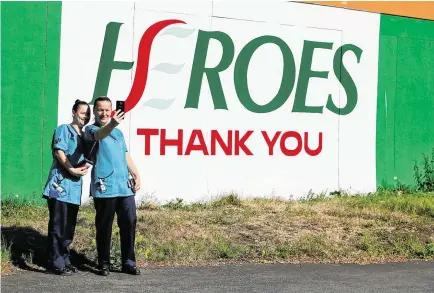  ?? PHOTO: BRIAN LAW ?? Frontline heroes: Linda Rochford (right) and Sophia Kelly, who work in catering at St James’s Hospital in Dublin, take a photo in front of a new mural thanking Health Service Executive workers for their efforts in the fight against the coronaviru­s pandemic.