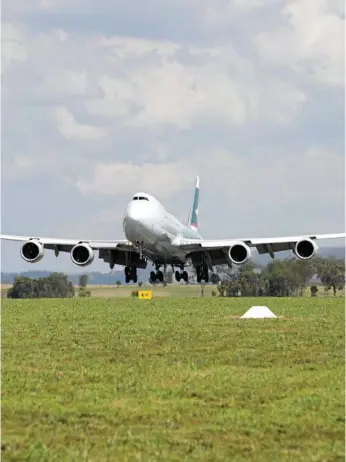  ?? Photo: Kevin Farmer ?? QUEEN OF THE SKIES: The Cathay Pacific Boeing 747-8 cargo plane flies into Wellcamp Airport to load up before it heads to Hong Kong.