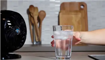  ??  ?? Staying hydrated and getting the air moving in your kitchen are two easy ways to keep your cool when it feels too hot to cook. — Photo by Deb Lindsey for The Washington Post.