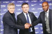  ??  ?? In this Jan 14, 2020 file photo, coach Quique Setien poses with FC Barcelona’s President Josep Maria Bartomeu (center), and director of football Eric Abidal (right), while being officially introduced as the club’s
new coach at the Camp Nou Stadium in Barcelona, Spain. (AP)