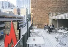  ??  ?? Ron Schuyler, left. of Mount Washington, Peter Rich of North Fayette and Theo Collins of Coraopolis lunch on the roof of Harris Grill, Downtown.