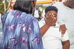  ?? ARIEL COBBERT/ COMMERCIAL APPEAL ?? Crowds gather at the intersecti­on of Joy Lane and Airways Boulevard in South Memphis near the scene of a fatal shooting that reportedly killed Memphis rapper Young Dolph on Nov. 17.