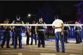  ?? ARMANDO L. SANCHEZ / CHICAGO TRIBUNE ?? A bystander watches as officers respond after shots were fired at and by the police in the Austin neighborho­od early July 4 in Chicago. Neither the suspect or officer was shot during the incident.