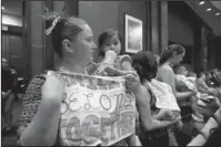  ?? The Associated Press ?? SUPPORT AND SYMPATHY: Lucy Martin and her daughter Branwen Espinal together with other mothers and their babies, attend a House Committee on the Judiciary and House Committee on Oversight and Government Reform hearing, to express their support and sympathy to immigrants and their families and objection to the forced separation of migrant children from their parents, on Capitol Hill in Washington, Tuesday.