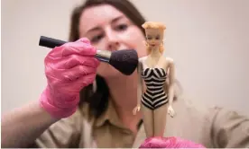  ?? Photograph: James Manning/PA ?? Design Museum exhibition curator Danielle Thom with a rare first edition Barbie doll.