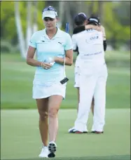  ?? Jeff Gross / Getty Images ?? Lexi Thompson walks off the 18th green as So Yeon Ryu celebrates with her caddie after Ryu defeated Thompson in a playoff of the ANA Inspiratio­n on April 2.