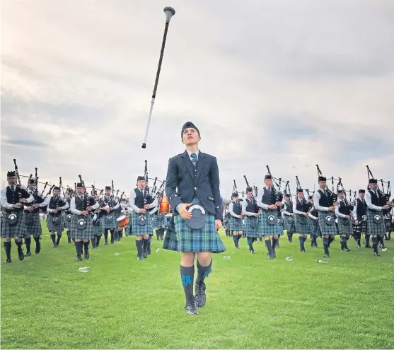  ?? Picture: Mackenzie Caledonian Pipe Band. ?? Drum Major Jamie Cupples leading the Mackenzie Caledonian Pipe Band at the UK Championsh­ips.