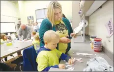  ??  ?? Shawnda Craig, a teacher at Decatur Pre-K, cuts out paper frogs with Eli Mitchell, a prekinderg­arten student, at the Community Creative Center at the Walton Arts Center’s Nadine Baum Studios in Fayettevil­le. The students watched a performanc­e of Frog and Toad by Trike Theatre and then created frogs at the studios.
(NWA Democrat-Gazette/David Gottschalk)