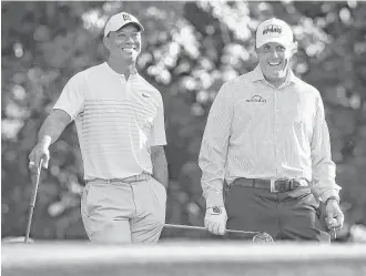  ?? Curtis Compton / Tribune News Service ?? Tiger Woods, left, and Phil Mickelson enjoy a practice round Tuesday at Augusta National.