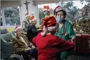  ?? BERNAT ARMANGUE - THE ASSOCIATED PRESS ?? Residents of an elderly care home celebrate Christmas Eve in Pozuelo de Alarcon, outskirts of Madrid, Thursday, Dec. 24. Many of the elderly in the residence haven’t celebrate Christmas Eve with their relatives to prevent the spread of coronaviru­s.