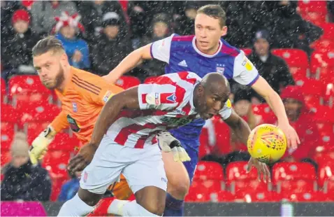  ??  ?? NO WAY THROUGH: Stoke City striker Benik Afobe tries to force his way past Ipswich goalkeeper Dean Gerken and defender Matt Pennington, but was thwarted on this occasion.