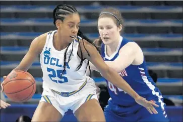  ?? Luis Sinco Los Angeles Times ?? FORWARD MONIQUE BILLINGS, dribbling against Cecily Carl in UCLA’s 71-60 victory over American on Saturday in a first-round game of the NCAA tournament, has 46 double-doubles in four seasons at UCLA.