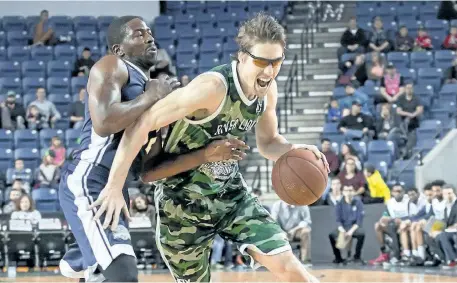  ?? COLIN DEWAR/SPECIAL TO POSTMEDIA NETWORK ?? Niagara River Lions' Logan Stutz drives to the net as Anthony Anderson of the Saint John Ridtide defends during Canadian basketball league action at Meridian Centre Sunday afternoon.